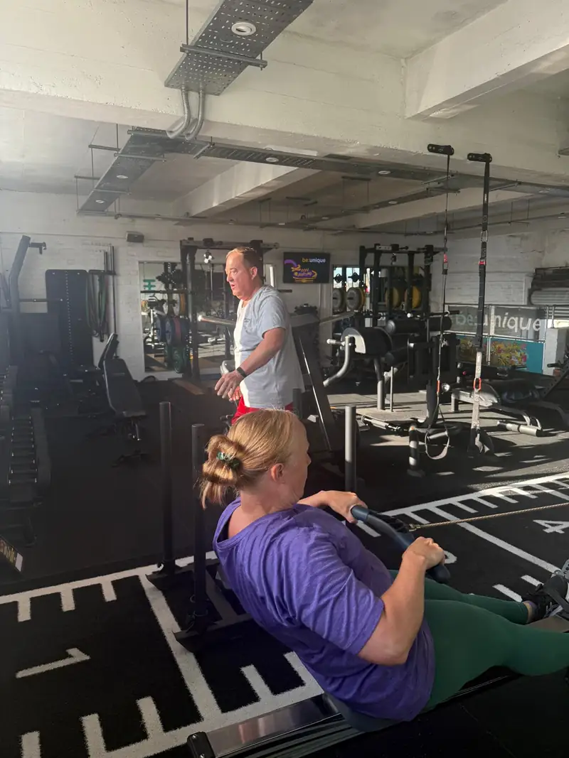 A coach beside a member during a personal training session
